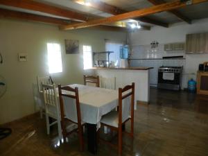 a kitchen with a table and chairs in a room at CASA DESERT in San Pedro de Atacama