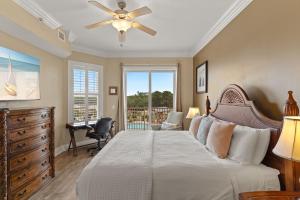 a bedroom with a bed and a desk and a window at Sanctuary at Redfish 2115 by Newman-Dailey in Santa Rosa Beach
