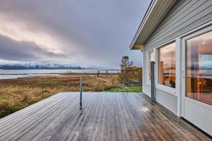 a porch of a house with a view of the water at Roksoy for rent in Sortland