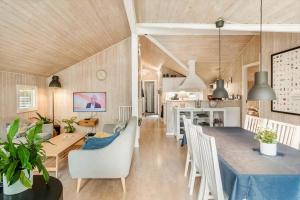 a dining room and kitchen with a table and chairs at M396-Vaeggerlose-Torilisvej-3 in Bøtø By