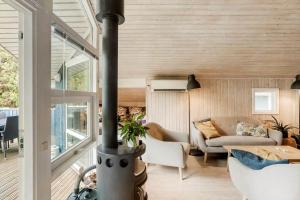 a living room with a fireplace in a house at M396-Vaeggerlose-Torilisvej-3 in Bøtø By