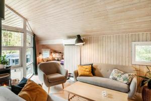 a living room with a couch and a chair at M396-Vaeggerlose-Torilisvej-3 in Bøtø By