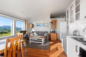a kitchen and living room with a couch and a table at Roksoy for rent in Sortland