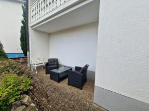 a patio with two chairs and a table at Monteurenwohnung Chez Danou in Idar-Oberstein