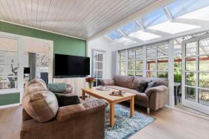 a living room with a couch and a table at 84300-Ebeltoft-Bogfinkevej-17 in Fuglslev