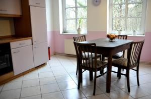 a kitchen with a table and chairs in a room at Cafe-Kuckuck in Salzwedel