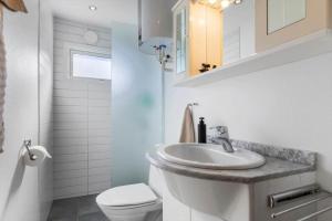 a bathroom with a sink and a toilet at 84300-Ebeltoft-Bogfinkevej-17 in Fuglslev +16 photos