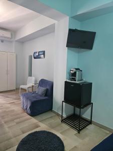 a living room with a couch and a tv at Bari Vecchia Dimora in Bari