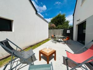 a patio with two chairs and a table at Casa Avrillé in Avrillé