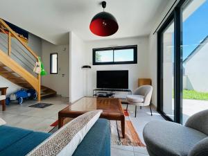 a living room with a couch and a table at Casa Avrillé in Avrillé