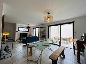 a living room with a table and a couch at Casa Avrillé in Avrillé +31 photos