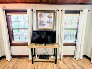a living room with a tv and two windows at #09 - Large Lakeview One Bedroom- Pet Friendly in Hot Springs