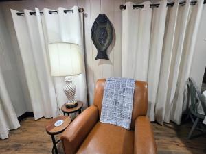 a living room with a couch and a lamp and curtains at #09 - Large Lakeview One Bedroom- Pet Friendly in Hot Springs
