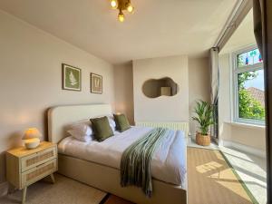 a bedroom with a bed and a window at Shrubbery Lodge - Games Room & Patio Dining in Wyke Regis