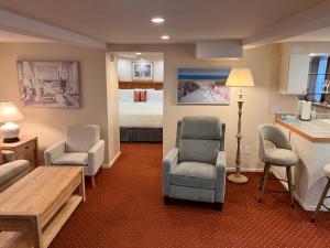 a hotel room with a bed and a living room at Briarwood Inn in Carmel