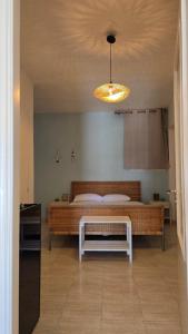a bedroom with a bed and a table and a light at Teos Sunset View Apartment in Batsi