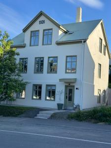 a white house with the number on it at Downtown Boutique Apartment in Akureyri