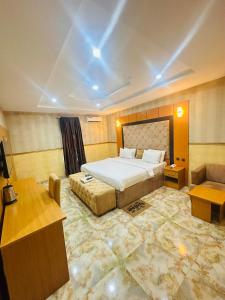 a hotel room with a bed and a couch at Goldstep hotel Okpaka in Warri