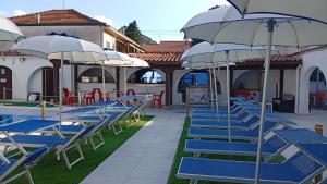 a group of blue and white chairs and umbrellas at Hotel Elite in Turin