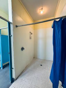 a bathroom with a shower and a tiled floor at Buffalo’s River Den in Buffalo