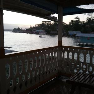 
a boat sitting on a dock near a body of water at Hotel Caribbean View in Bocas Town
