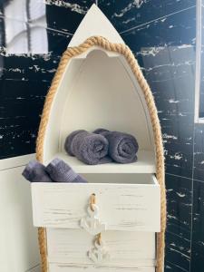 a wooden shelf with towels in a bath room at Appartement "Hörnli Seeliebe" in Kreuzlingen +21 photos