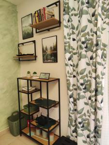 a room with a book shelf and a curtain at Студио Forest, к-с Нестинарка in Tsarevo