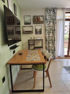 a dining room with a wooden table and chairs at Студио Forest, к-с Нестинарка in Tsarevo