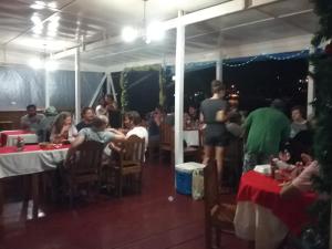 a group of people sitting at tables in a restaurant at Hotel Caribbean View in Bocas Town
