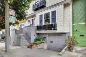 a house with a green door and a garage at Quiet Studio near Glen Park in San Francisco