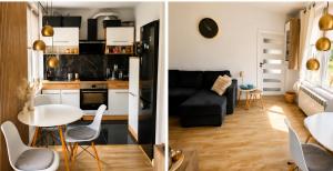 a kitchen and a living room with a table and chairs at Kamienica Centrum in Pisz