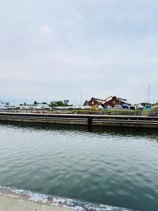 a large body of water with a pier and buildings at Buffalo’s River Den in Buffalo