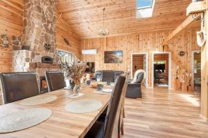a wooden dining room with a table and chairs at L40-Rodby-Glentevej-11 in Rødby