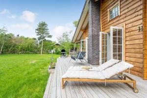 a wooden deck with a couch on a house at L40-Rodby-Glentevej-11 in Rødby