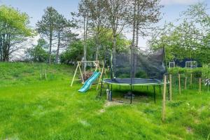 a playground with a trampoline in a field at L40-Rodby-Glentevej-11 in Rødby