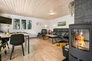 a living room with a fireplace and a couch at C11252-hemmet-Anevej-7 in Hemmet