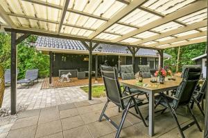 a patio with a table and chairs under a pergola at C11252-hemmet-Anevej-7 in Hemmet +33 photos