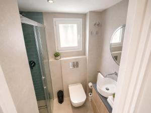 a bathroom with a toilet and a sink and a mirror at Beach Apartment in Torre del Mar in Torre del Mar +3 photos