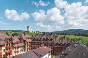a view of a town with houses and a clock tower at Appartamento Belvedere in Asiago