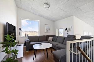 a living room with a couch and a table at 1166-Ringkobing-Havstien-388 in Søndervig