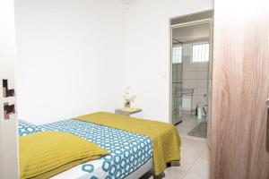 a bedroom with a bed with a yellow and blue blanket at Villa Syleone in Sainte-Marie