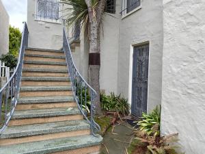 a staircase leading to a building with a door and a palm tree at Spacious Private Suite ParksBoatingGolf in San Francisco
