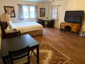 a living room with a bed and a flat screen tv at Spacious Private Suite ParksBoatingGolf in San Francisco +15 photos