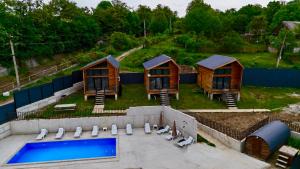 an aerial view of a group of huts with a pool at Sioni Hillside Cottages in Sioni