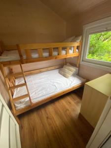 a small bedroom with bunk beds in a tiny house at Stały Ląd in Darlowko +74 photos