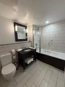 a bathroom with a toilet and a sink and a tub at Fenwick Street Hotel by EPIC, Central Rooms Near Waterfront & Liverpool ONE in Liverpool