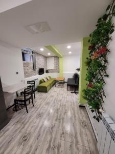 a living room with a green couch and a table at Дом 33 возле клиники Астхик in Yerevan +26 photos