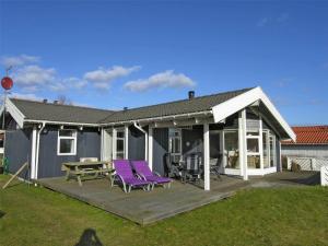 a house with purple chairs and a wooden deck at 30098-Malling-Norsmindevej-171-K in Malling