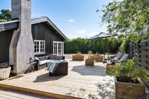 a patio with couches and chairs on a wooden deck at 30192-Malling-Askvaenget-13 in Malling +35 photos