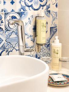 a bathroom with blue and white tiles and a sink at Domus Maris Relais Boutique Hotel in Sciacca +91 photos